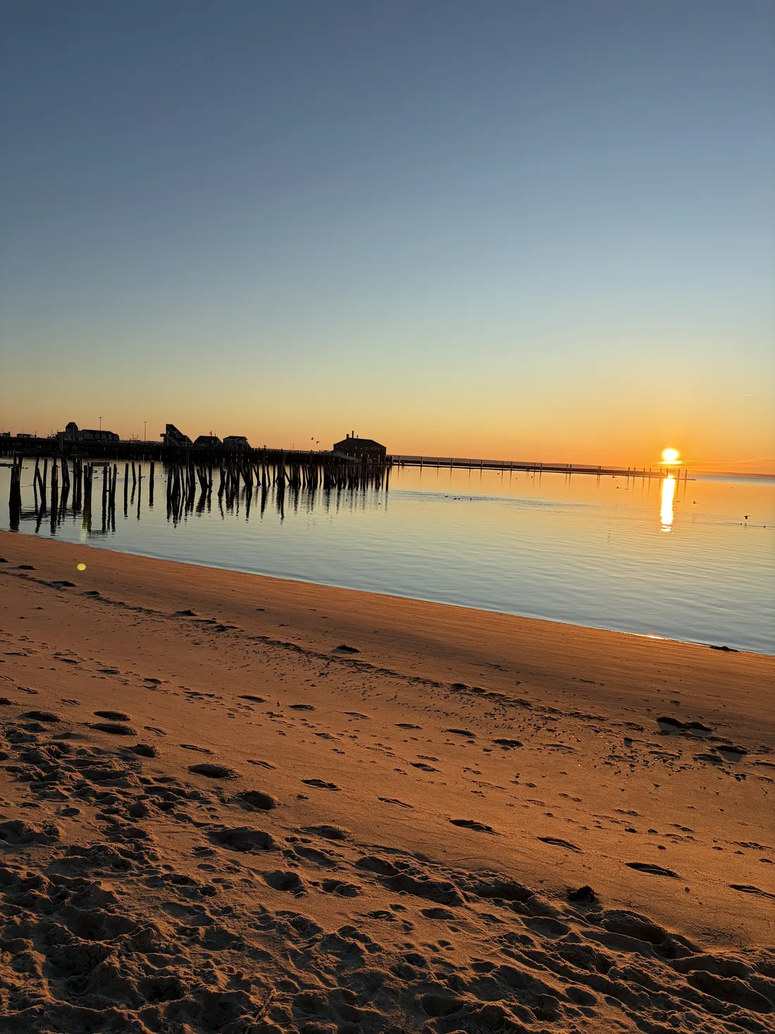 Golden sunset over Provincetown Harbor and Cape Cod Bay