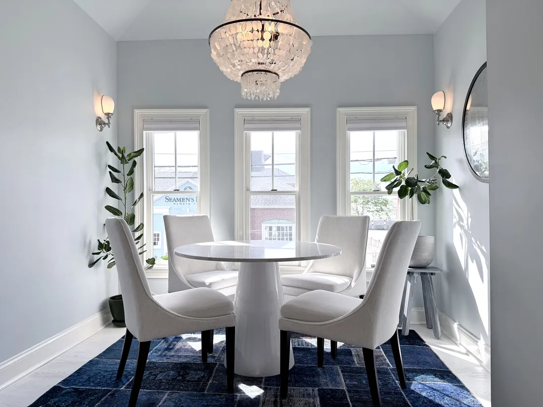 The bright dining room at Ptown Perch with bay windows overlooking Commercial Street