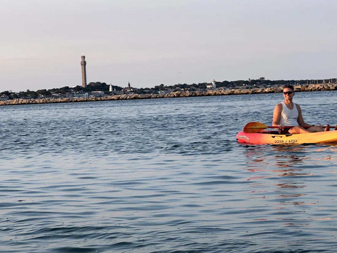 Kayaking on calm water with the Pilgrim Monument in the distance